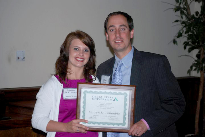 Jeffrey Farris (right) director of Alumni Affairs at Delta State presents the 2011 H.L. Nowell Service Award to Lauren St. Columbia.